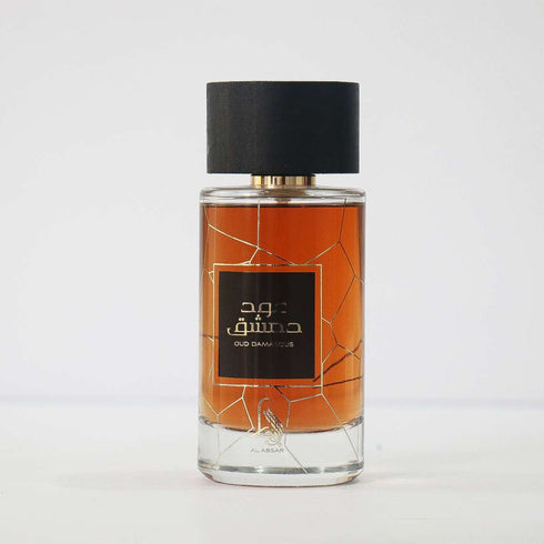 Al Absar Oud Damascus 100ml eau de parfum bottle, amber oud juice, on a neutral studio background